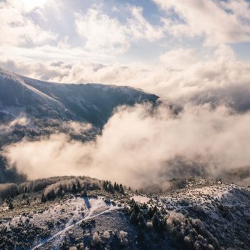 Early booking at Kopaonik mountain Ski resort. Mountain view over the clouds.